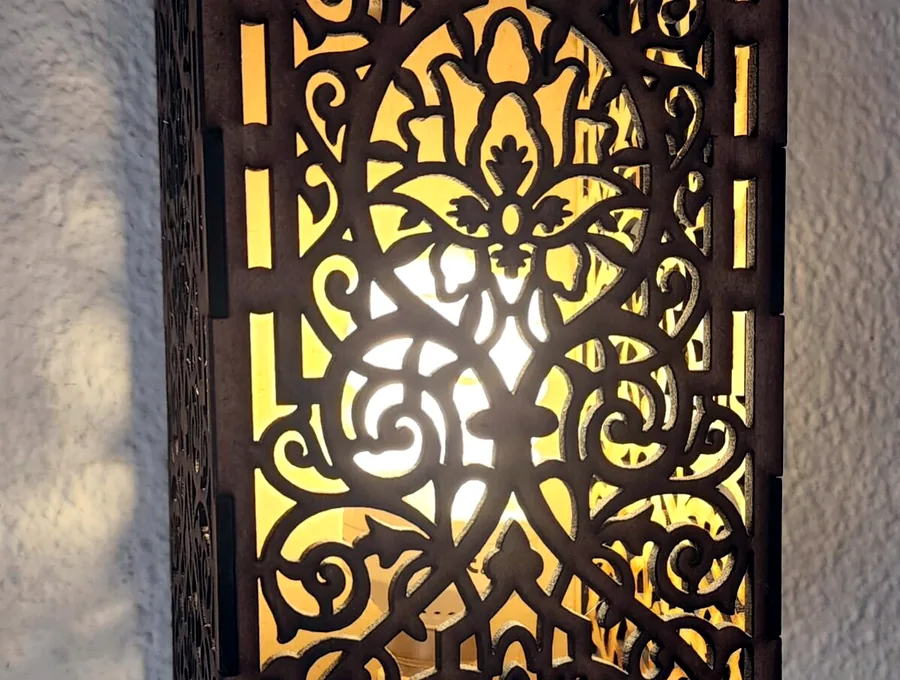 Decorative laser-cut lantern with warm light